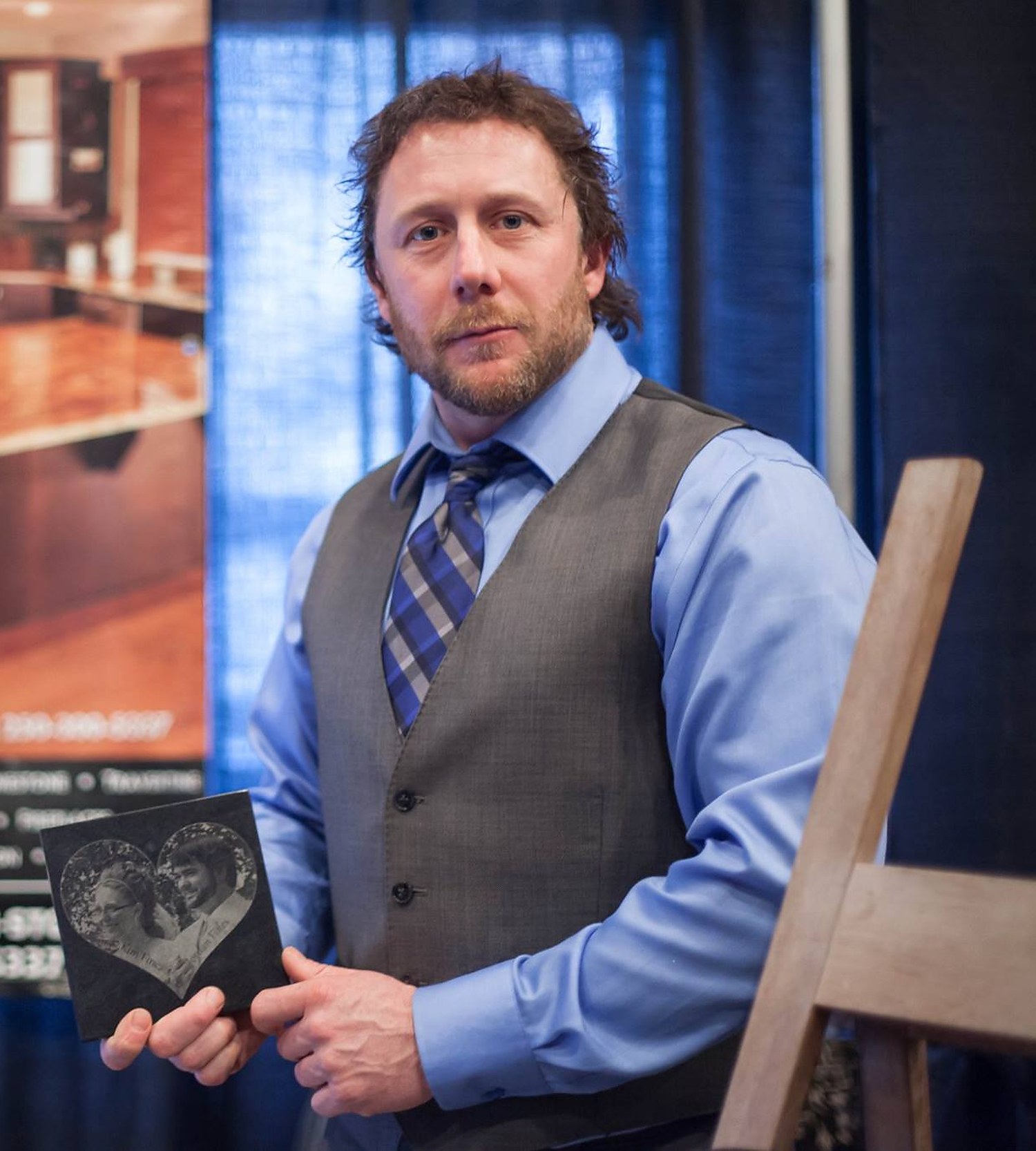 Dave Plummer holding a small engraved granite keepsake